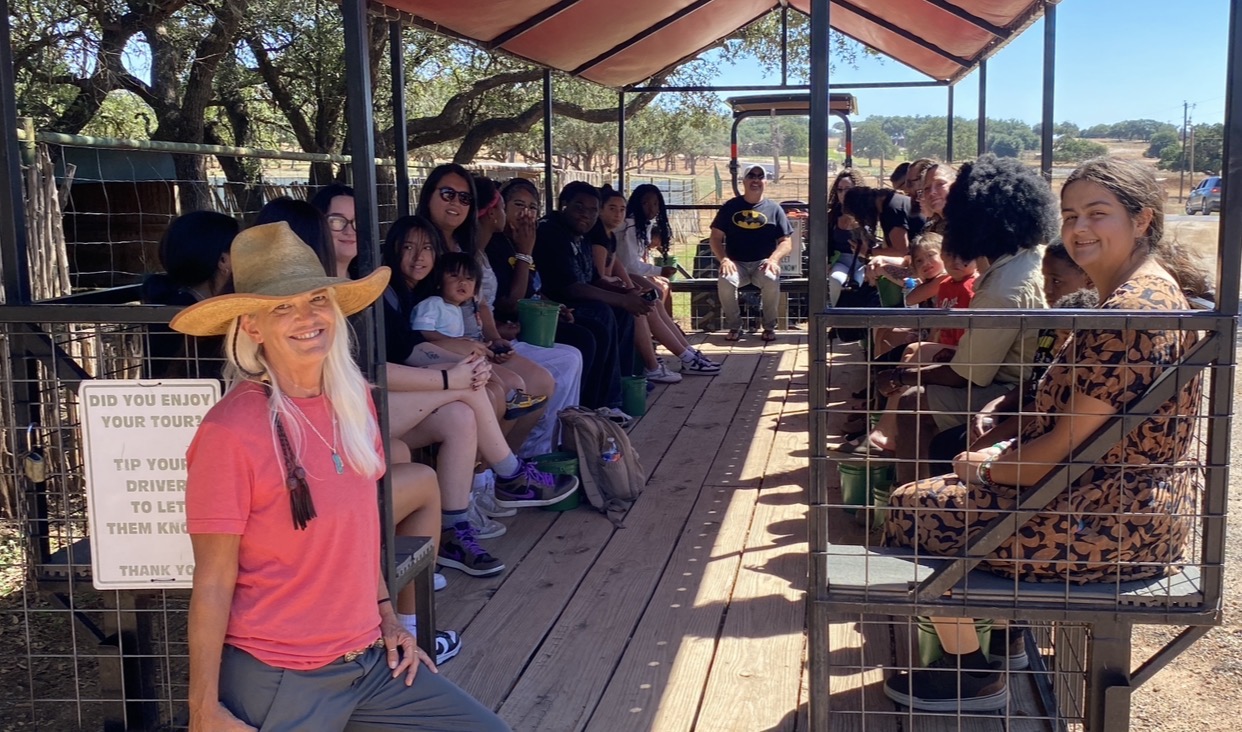 KINGDOM Kids children, teens, and adults enjoying a covered outdoor wagon tour together